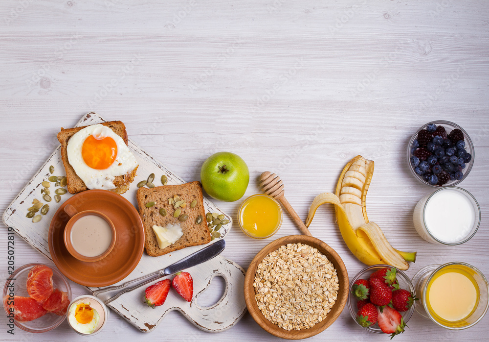 Breakfast served with coffee, orange juice, cereals, milk, fruits, eggs