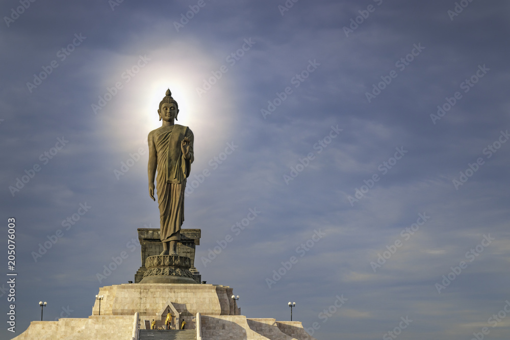 Buddha statue with a sky background and a flash of light over his head. Buddha statue with a sky background and a flash of light over his head.