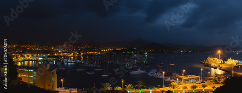 Mindelo in dusk light. Port town with many boats in the bay on the Cape Verde in the northern part of the island Sao Vicente. Long exposure panoramic shot of the bay