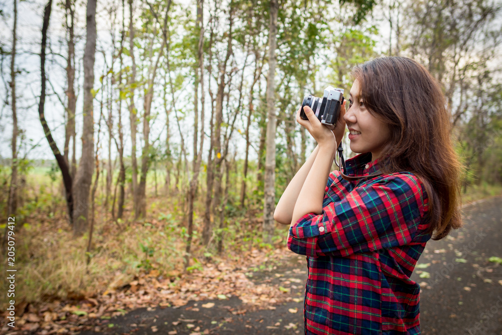 Young woman is taking nature with an old camera. Young woman is taking nature with an old camera.