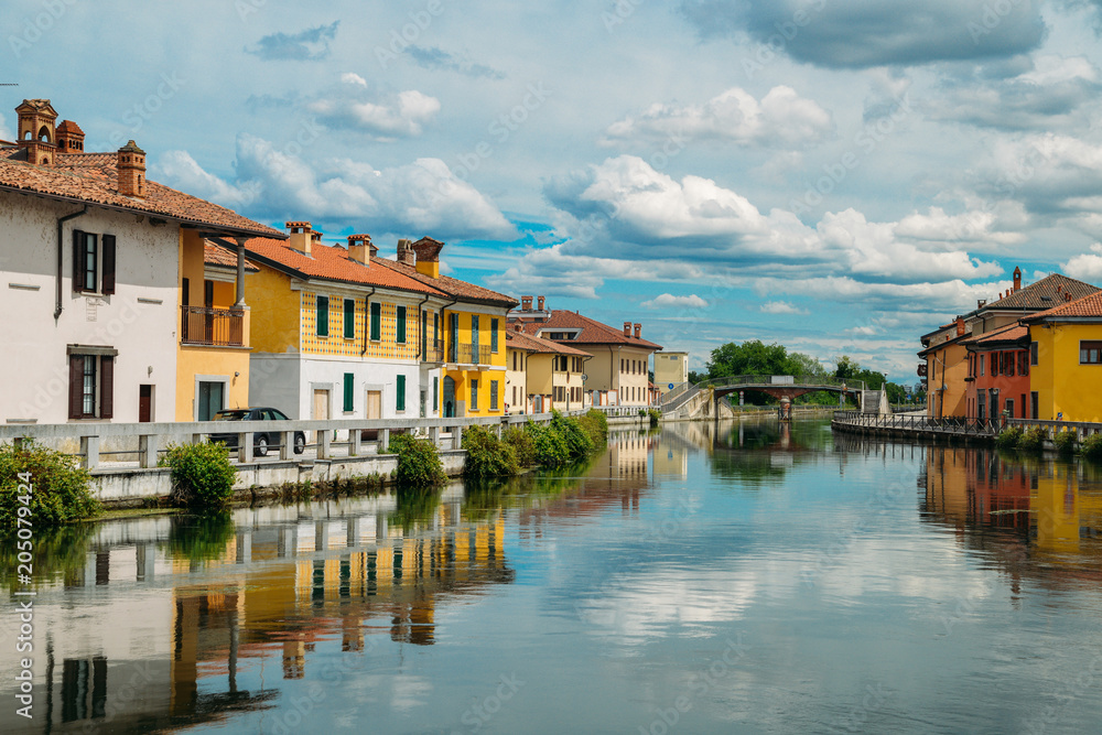 Naviglio Grande canal waterway passes near the historic and colorful buildings of Gaggiano Italy