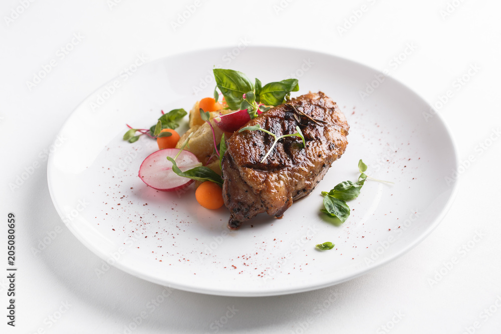 Roast duck breast with vegetables. Served on a white plate Roast duck breast with vegetables. Served on a white plate