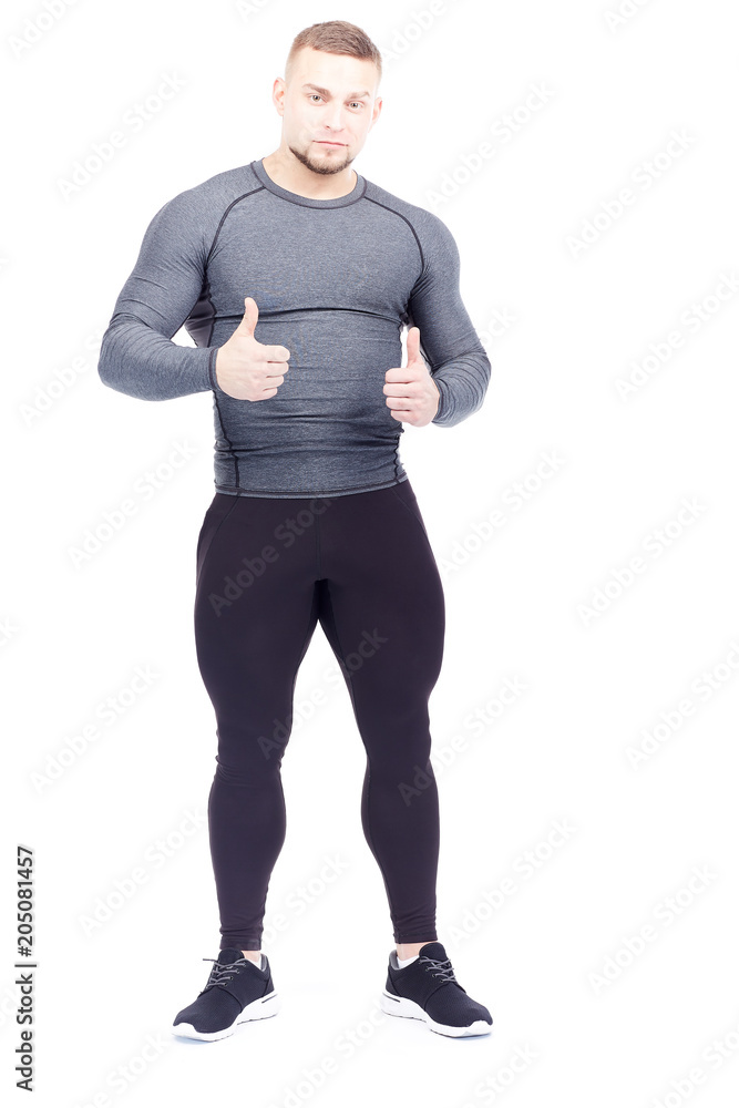 Portrait of handsome well-muscled gym instructor in sports tights and rashguard posing on white background Portrait of handsome well-muscled gym instructor in sports tights and rashguard posing on white background