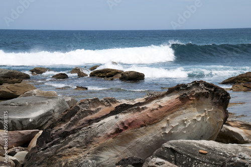 Bundena Australia, rocks on shoreline at Marley beach in the Royal National Park looking out to sea