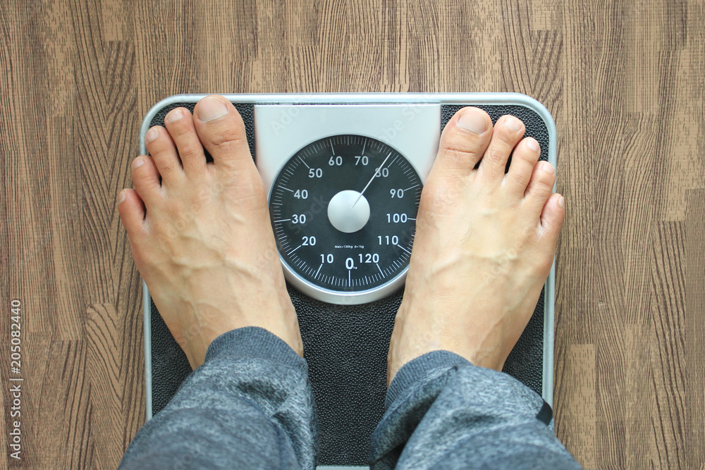 Male on the weight scale for check weight, Diet concept Stock Photo | Adobe  Stock