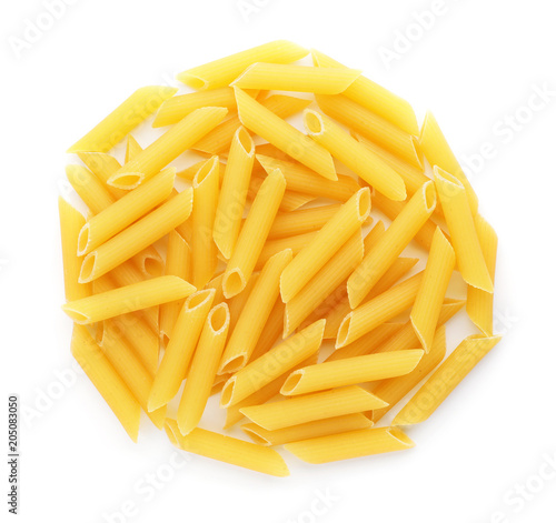 Uncooked penne pasta on white background, top view
