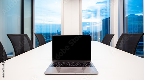 Wallpaper Mural modern laptop on foreground at meeting room with large windows, outside building, city, tower view, soft focus Torontodigital.ca