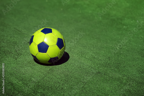 Bright colorful soccer ball on background of green grass of stadium training, playground, copy space, sport modern background