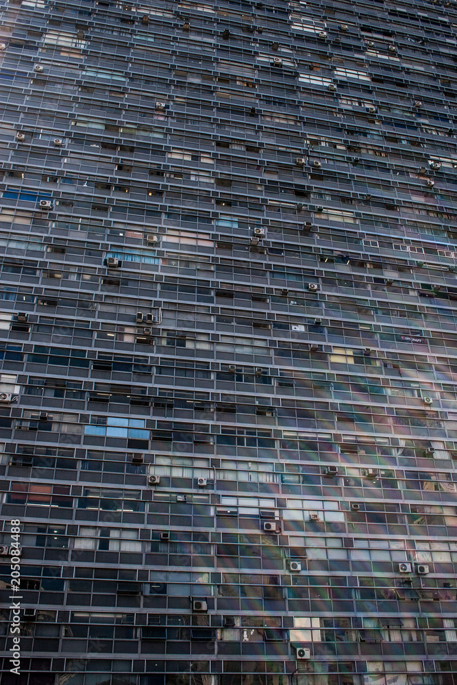 Vertical view of an office building with rectangular glass windows Vertical view of an office building with rectangular glass windows