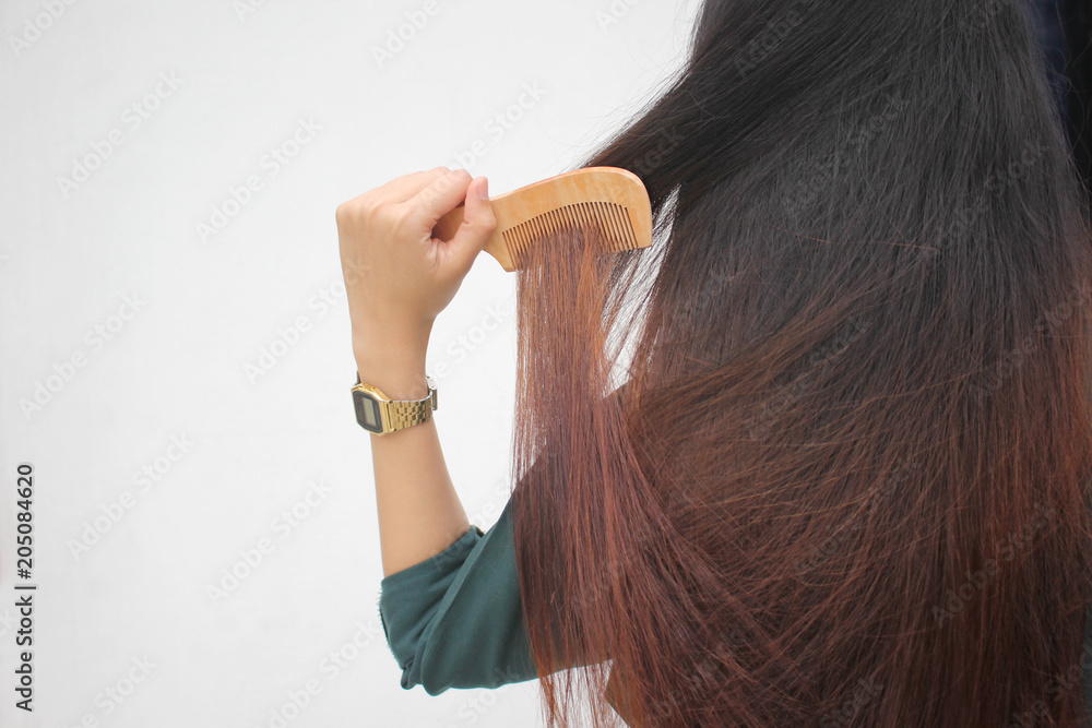 Woman holding combing with brush and clean long hair, Haircare concept Woman holding combing with brush and clean long hair, Haircare concept