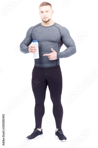 Isolated portrait of handsome athlete holding sports water bottle