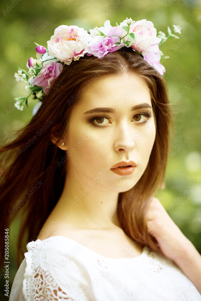 Young pretty woman in a white dress walking and posing in a forest near the river Young pretty woman in a white dress walking and posing in a forest near the river