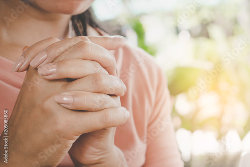 woman hand praying peacefully outdoors in the morning 