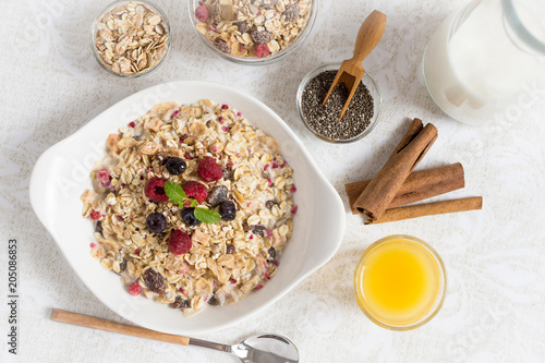 Sunny Morning with Healthy Breakfast. Muesli With Milk, Chia Seeds, Berries and Cinnamon.