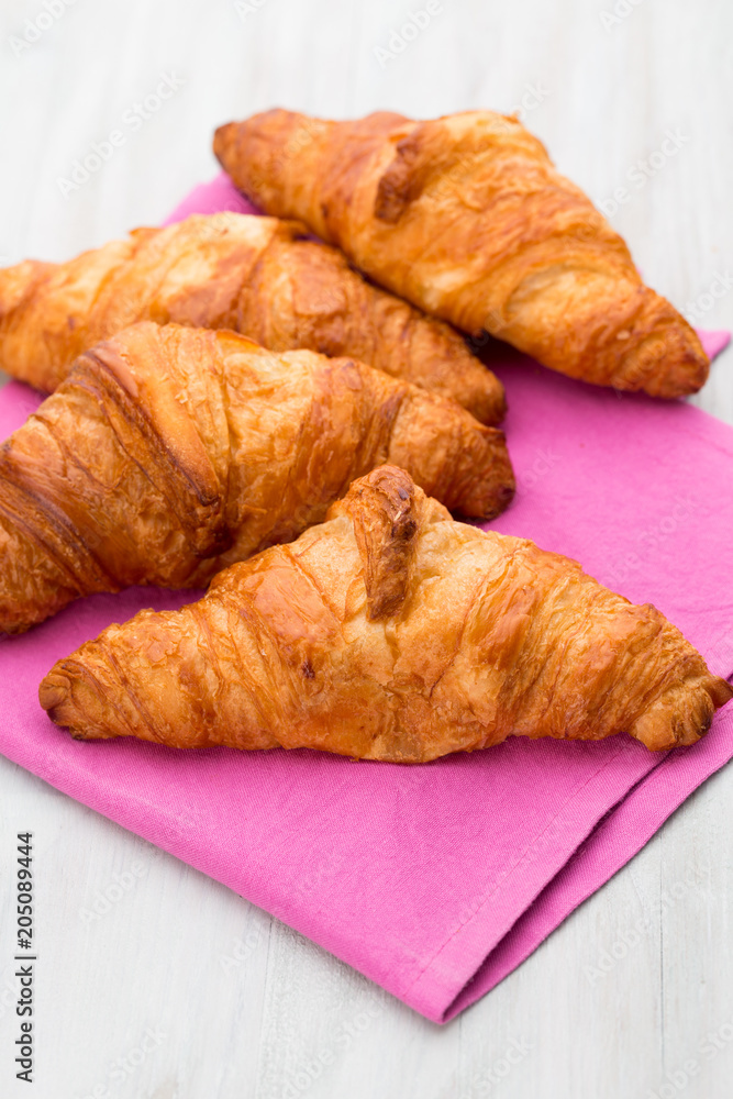 Tasty buttery croissants on old wooden table. Tasty buttery croissants on old wooden table.