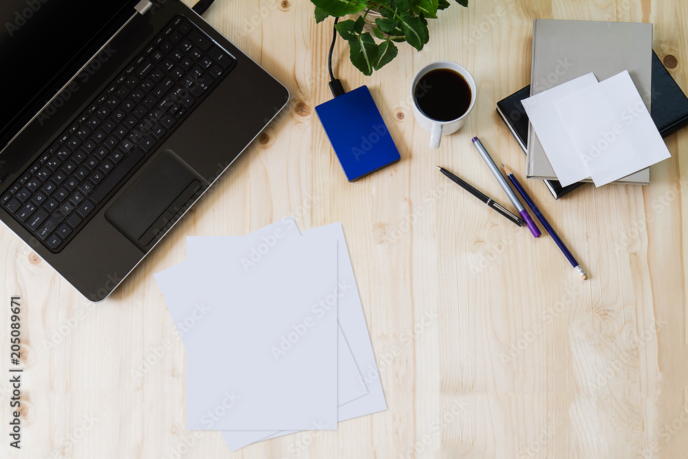 Laptop with busy office supplies on wooden desk, business concept Laptop with busy office supplies on wooden desk, business concept