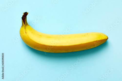 Close up of a ripe banana isolated on blue background.