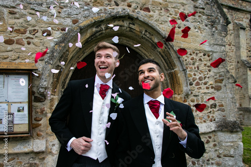Gay wedding, grooms leave village church after being married to smiles and confetti