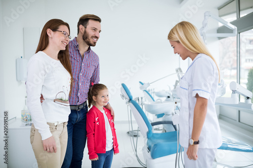 Dentist with sterile mask and dental instruments held exam teeth of patient