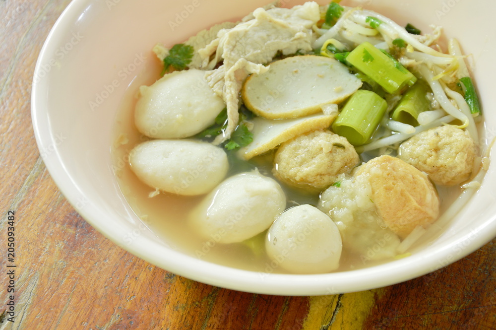 boiled fish and shrimp ball topping slice pork in clear soup on bowl boiled fish and shrimp ball topping slice pork in clear soup on bowl