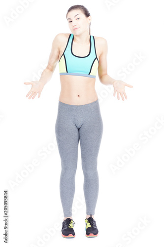 Isolated portrait of beautiful fit woman posing in sports tights and bra © Mediaphotos