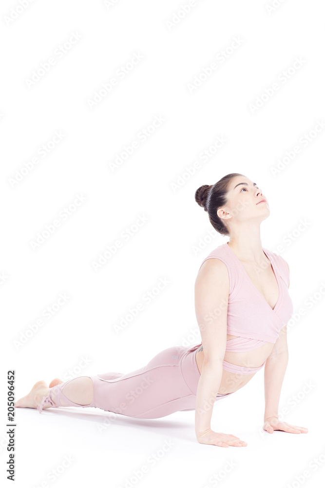 Young woman, professional yoga instructor practicing asanas isolated on white Young woman, professional yoga instructor practicing asanas isolated on white