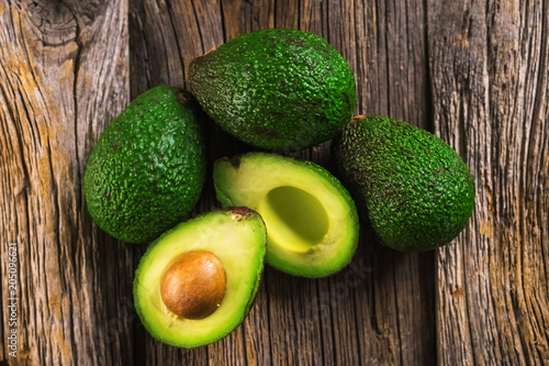 Avocados on wooden background