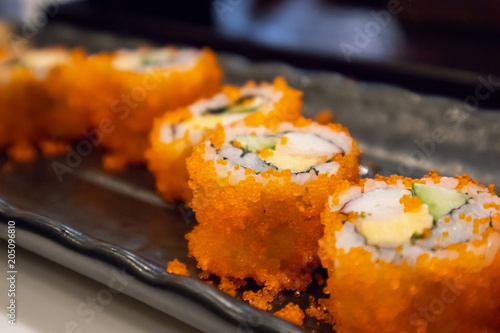 California maki sushi roll on black plate, japanese food
