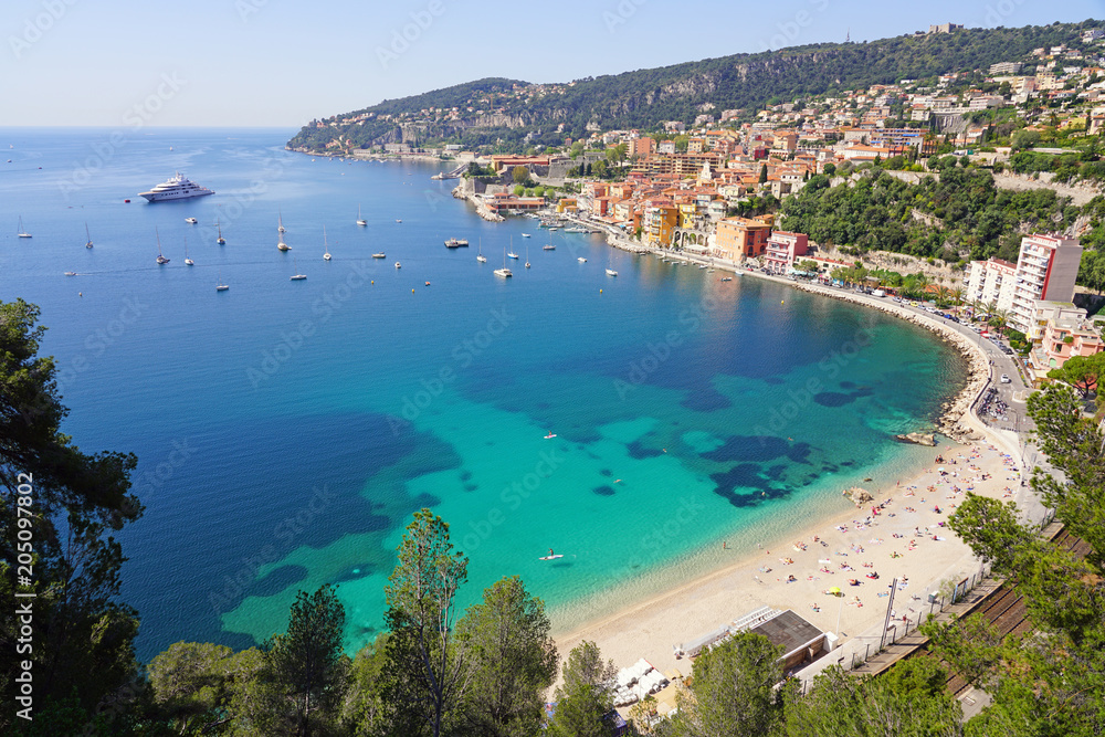 Panoramic view of the harbor town of Villefranche sur Mer, a coastal resort city on the Mediterranean Sea on the French Riviera seen from the Corniche