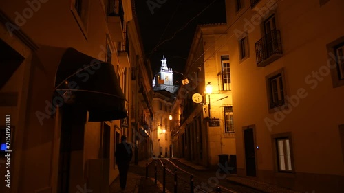 Quiet street at night with church tower, Lisbon.