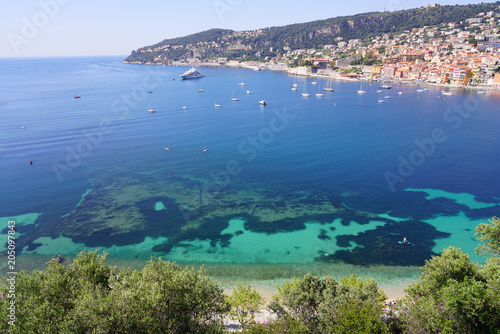 Panoramic view of the harbor town of Villefranche sur Mer, a coastal resort city on the Mediterranean Sea on the French Riviera seen from the Corniche © eqroy