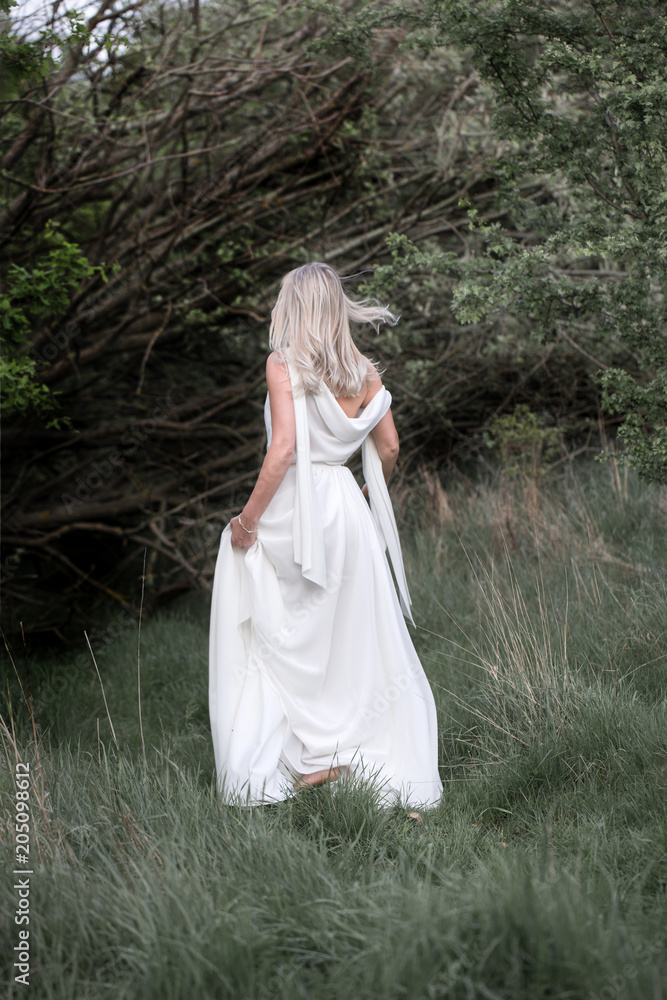 Beautiful woman - the bride. Boho style woman. Barefoot beautiful woman on the clearing. Natural, Nymph. Beautiful woman - the bride. Boho style woman. Barefoot beautiful woman on the clearing. Natural, Nymph.