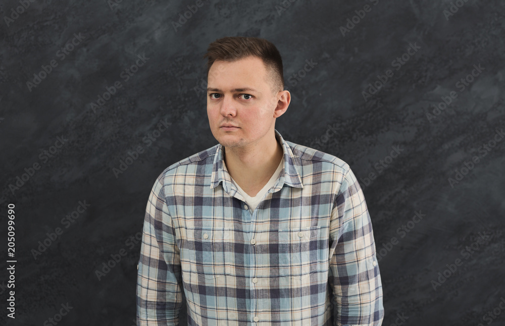 Suspicious young man looks doubtfully Suspicious young man looks doubtfully