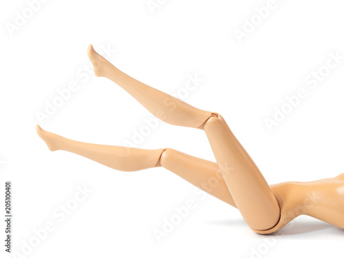 The beautiful slender legs of pretty figure girl doll doing gestures sexy isolated on white background