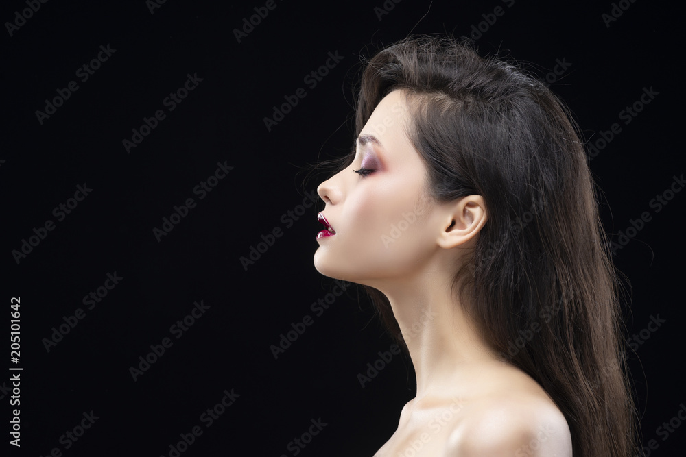 Portrait of a beautiful glamorous brunette girl sideways. Shimmering makeup, red lips. Healthy smooth skin. Portrait of a beautiful glamorous brunette girl sideways. Shimmering makeup, red lips. Healthy smooth skin.