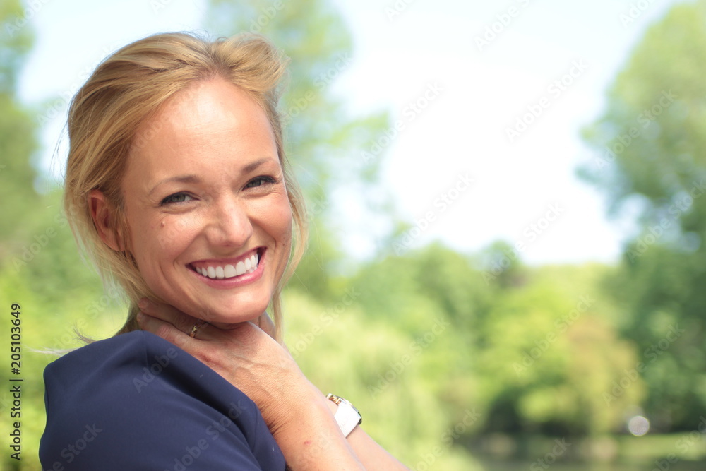 Beautiful woman in the park with a tablet or phone Beautiful woman in the park with a tablet or phone