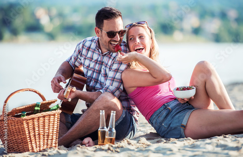 Beautiful young couple having fun on the beach. Lifestyle, love, dating, vacation concept