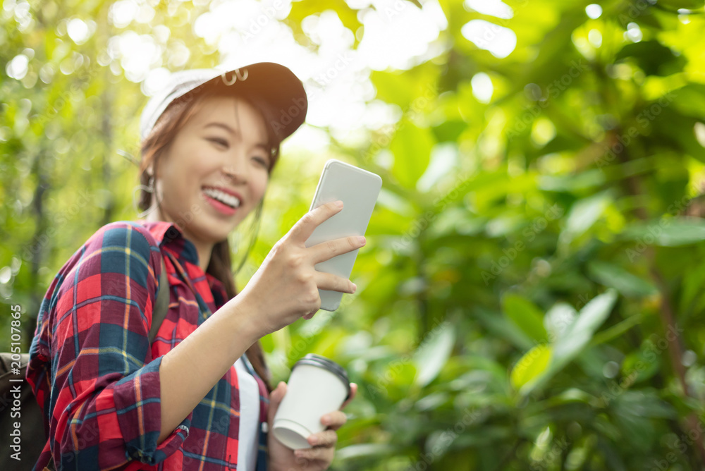 Relaxed Asian girl using digital map with smartphone. Relaxed Asian girl using digital map with smartphone.