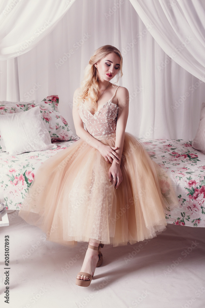 Fototapeta premium fashion studio photo of beautiful young girl with brown hair wearing luxurious beige dress,