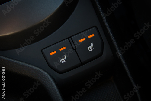 Seat heating buttons. Interior of car close up