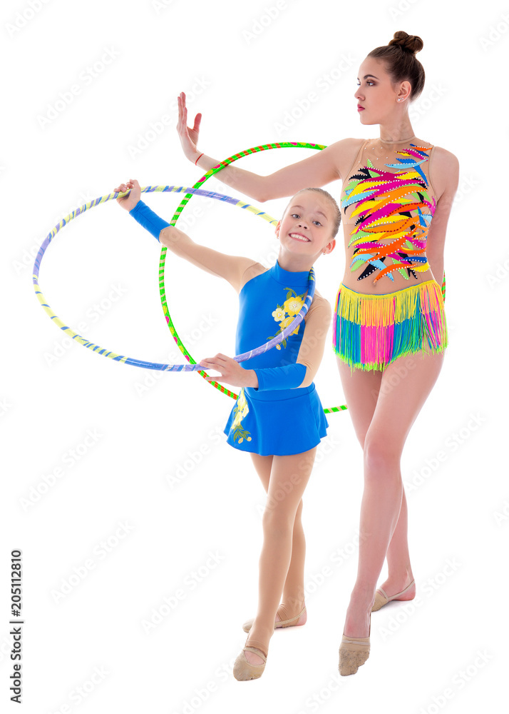 young woman and little girl doing gymnastics with hoops isolated on white young woman and little girl doing gymnastics with hoops isolated on white