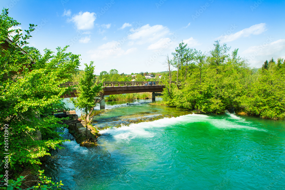 Fototapeta premium Panoramic view on waterfall and wooden bridge on Mreznica river in Belavici, Croatia 