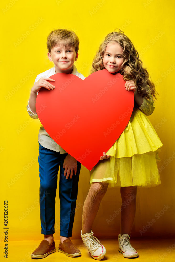 children holding big heart children holding big heart