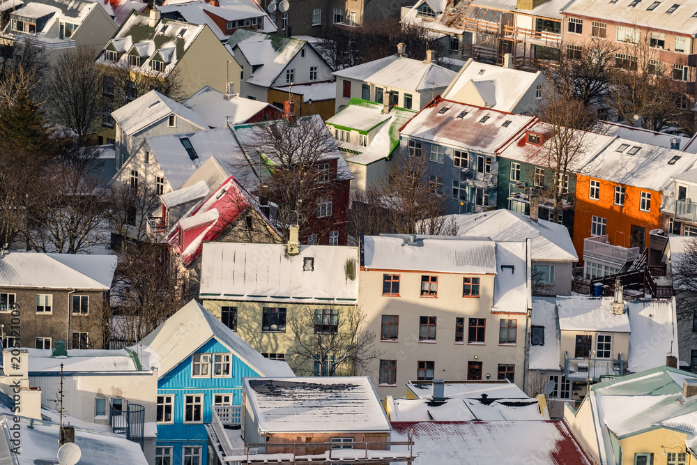 Aerial view of traditional urban developement in Reykjavik, Iceland in winter with snow covered roofs viewed from above.