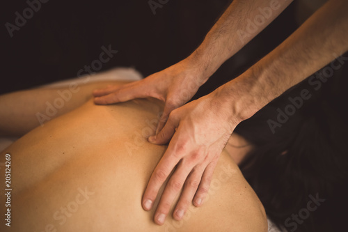 Message self care on caucasian woman in spa with male hands