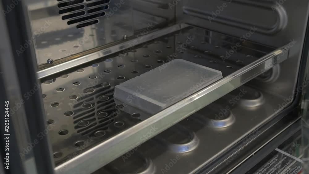 Scientist places samples in storage container, close up Scientist places samples in storage container, close up