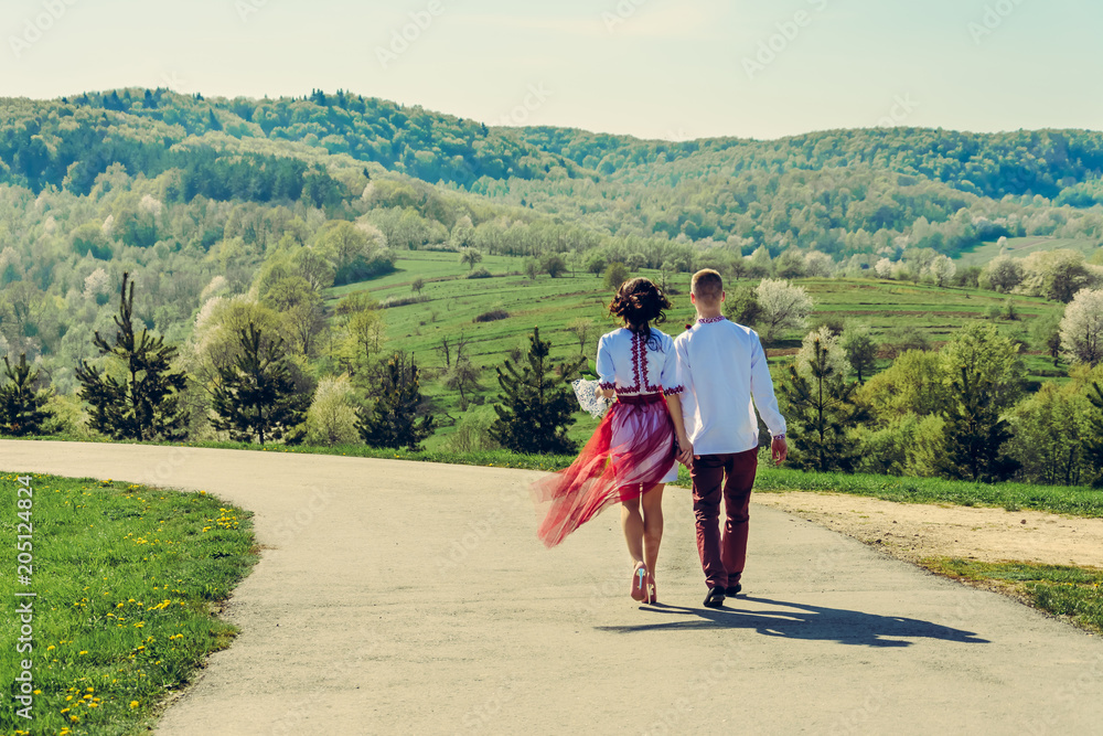 A young lovers couple goes back to the village on the Ukrainian way A young lovers couple goes back to the village on the Ukrainian way