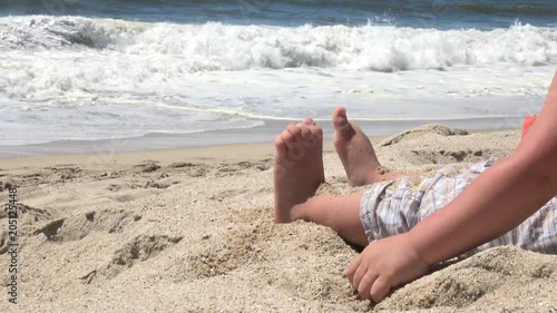 Child playing in sand on the beach