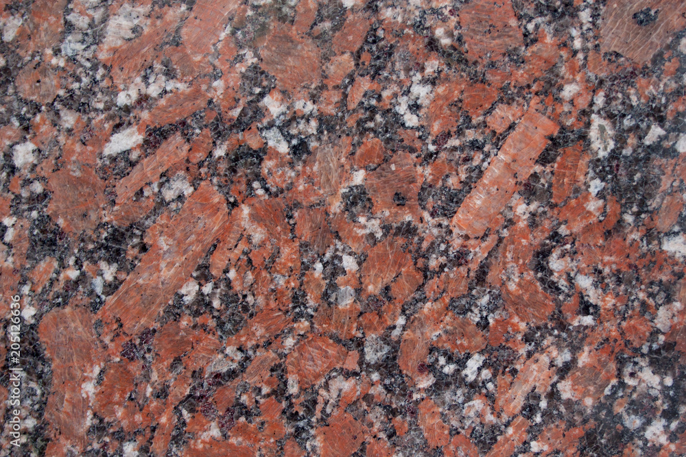 Fototapeta premium Reddish-brown granite texture with black and gray spots. Used as a background.