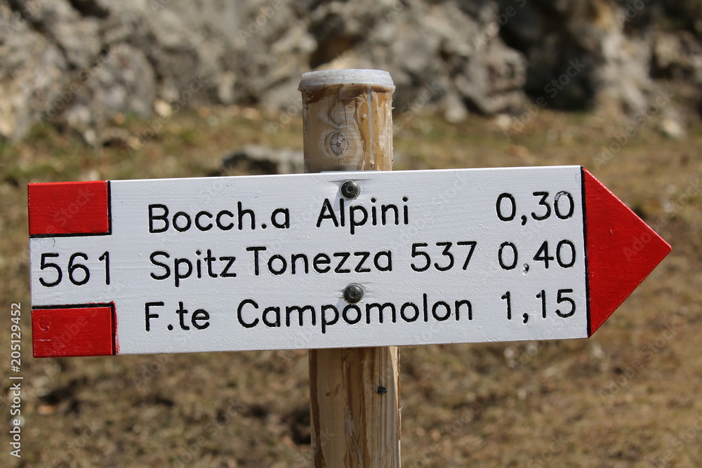 white and red sign showing the mountain trails